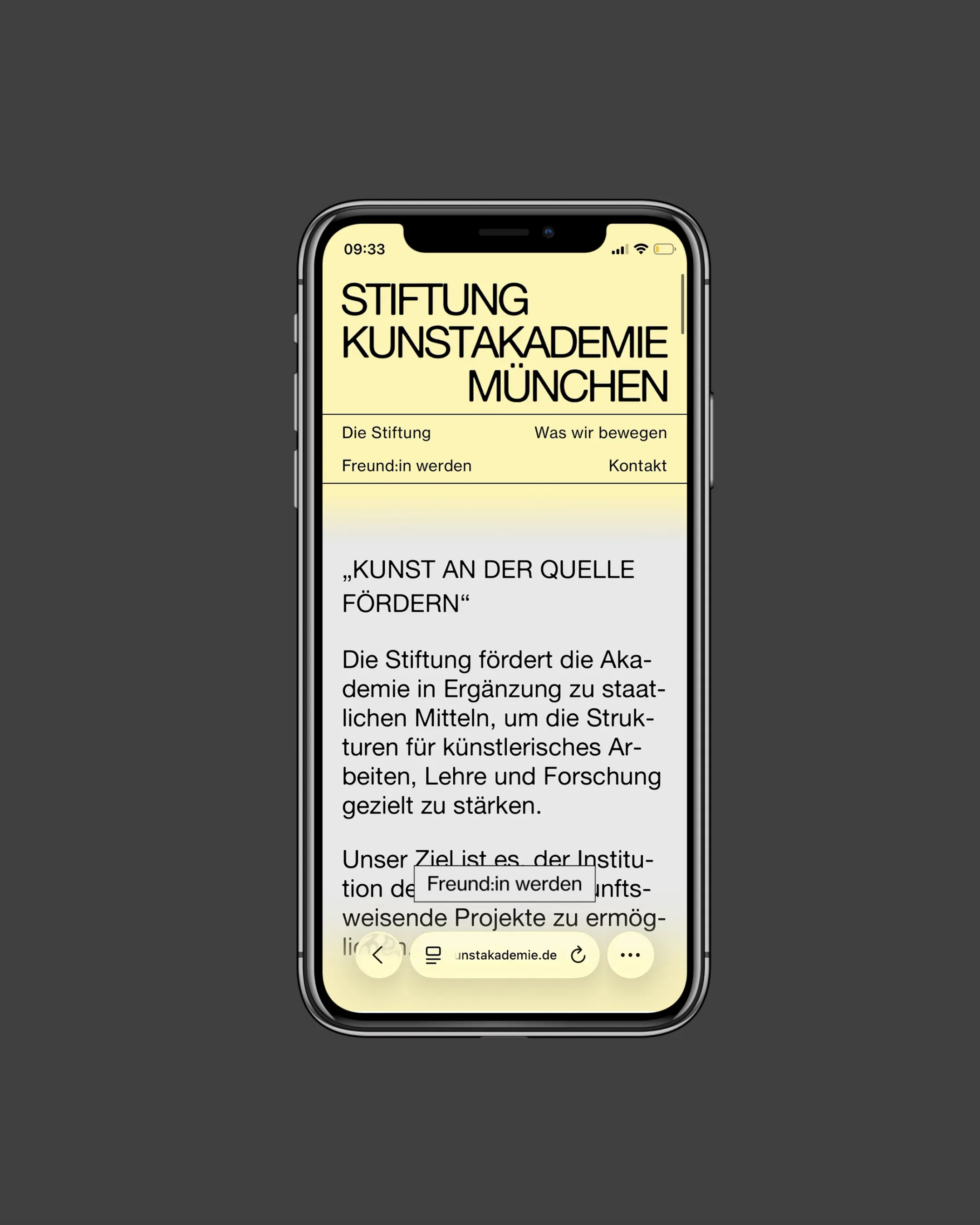 Smartphone auf grauem Grund mit der Website der Stiftung, welche einen grau-gelben Farbverlauf als Hintergrund hat